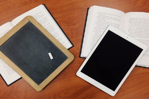 Books, a chalkboard and an iPad on a table